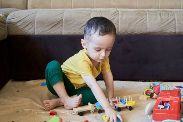 istock 3 years old kid playing at home 1337597994