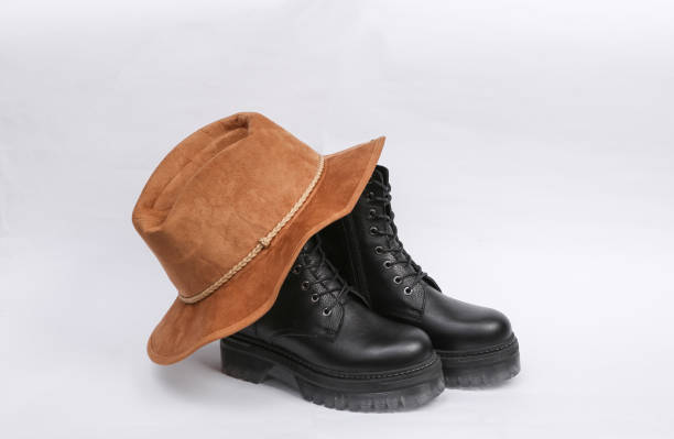 istock Black Fashionable high-soled leather boots and hat on white background 1337599496
