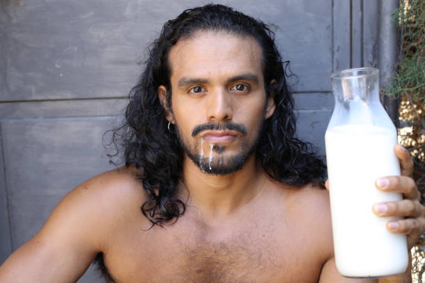 istock Sexy long haired man drinking milk 1337600362