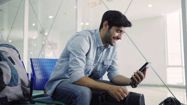 istock Man having video call on airport 1337600695