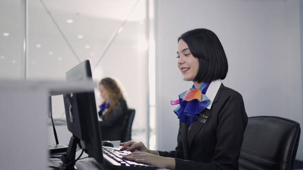 Portrait of a female staff at airport check in desk stock photo