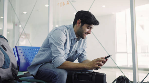 istock Man having video call on airport 1337600847