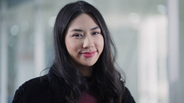 istock Happy asian young woman looking at camera 1337601004