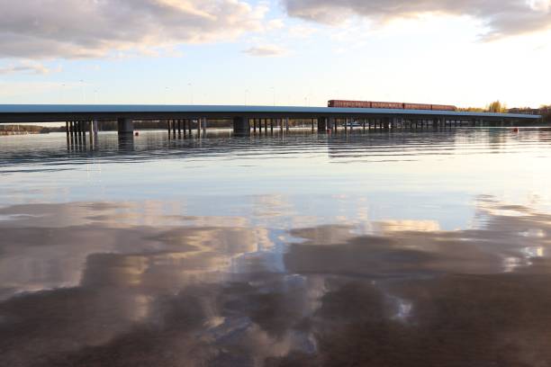 istock Metro train on bridge with reflections on sea 1337601977