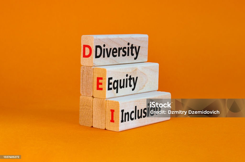 DEI, Diversity, equity, inclusion symbol. Wooden blocks with words DEI, diversity, equity, inclusion on beautiful orange background. Business, DEI, diversity, equity, inclusion concept. Diversity Stock Photo