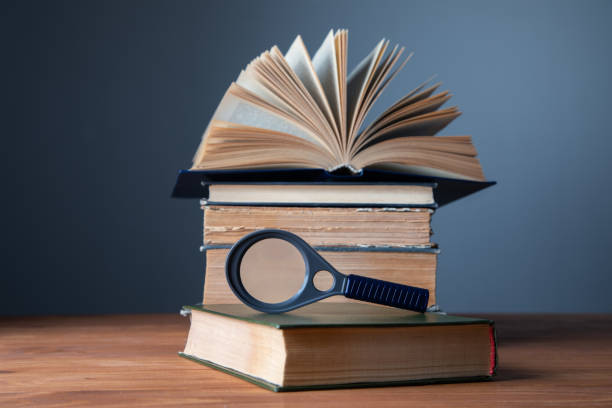 istock old books with magnifying glass on the table 1337605515