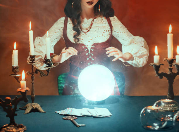 Silhouette of Fantasy women's hands close-up, witch feel energy magic of glowing crystal ball. Red room. Photo of old art vintage astrology. Fortune teller woman reading future on magical tarot cards silueta de las manos de las mujeres de fantasía primer plano, bruja siente la magia de la energía de la bola de cristal brillante. habitación roja. foto de la astrología vintage de arte antiguo. mujer adivina leyendo el futuro en cartas mágicas del ta