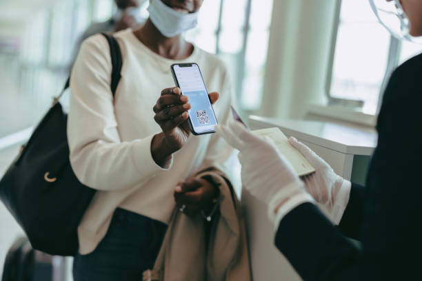 istock Ground attendant checking medical pass of passenger 1337607098
