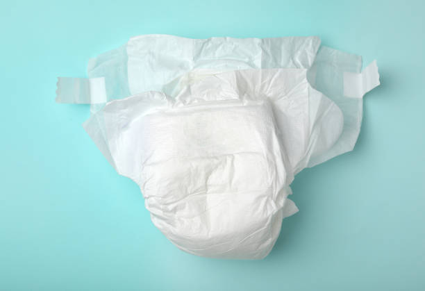 istock Baby diaper on turquoise background, top view 1337607431