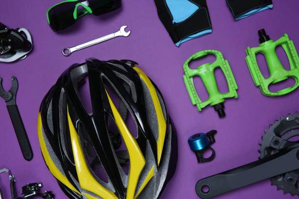 istock Set of different bicycle tools, accessories and parts on purple background, flat lay 1337607502