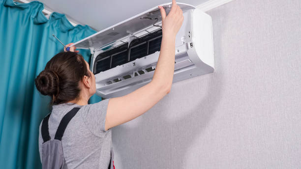 istock Apartment owner with screwdriver opens air conditioner lid 1337607530