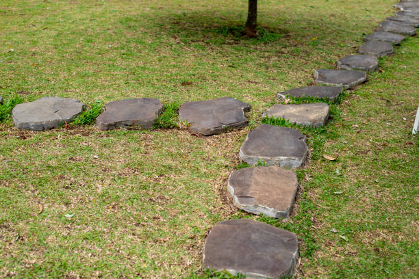 istock Stone path on a green grassy lawn. The way paved single stones among a green grass. 1337608934