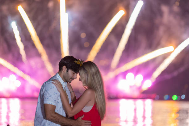 istock Young couple enjoy firework during celebration festival on the beach. 1337614141