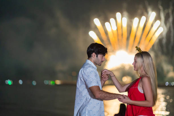 istock Young couple enjoy firework during celebration festival on the beach. 1337614144