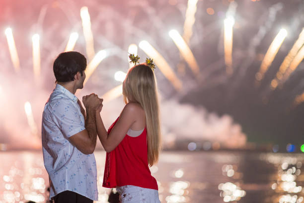 istock Young couple enjoy firework during celebration festival on the beach. 1337614146