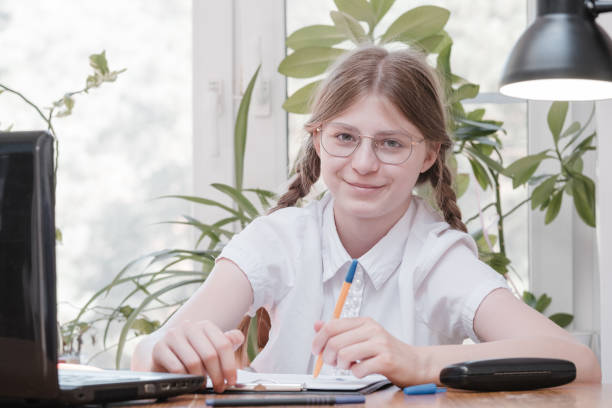 istock Portrait of female student enjoying learning in coworking office using laptop computer for research, freelancer during making project for remote job making notes. Pupil concentrated drawing notes 1337615651