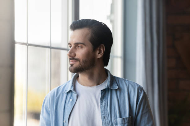 istock Pensive young man look in distance making plans 1337616401