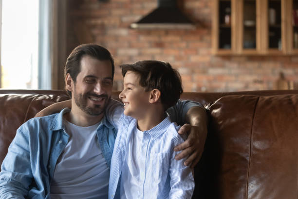 istock Smiling young father relax at home with small son 1337616423