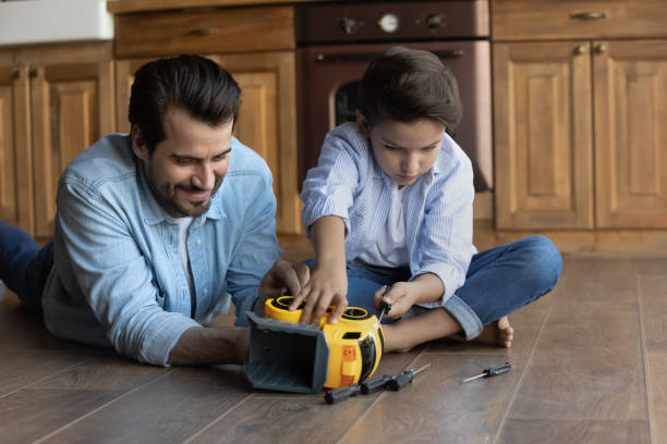 istock Playful young dad play toys with small son 1337616439