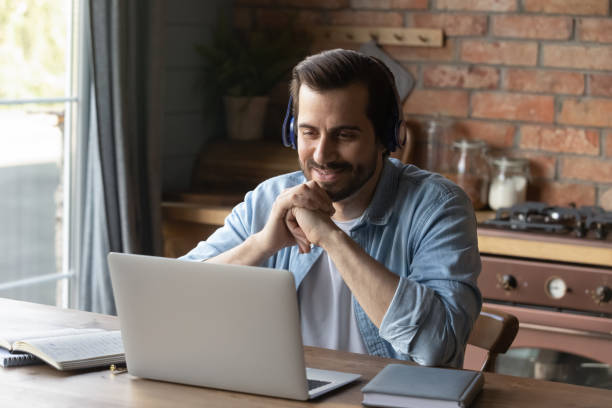 istock Smiling male student have webcam call on laptop 1337616503