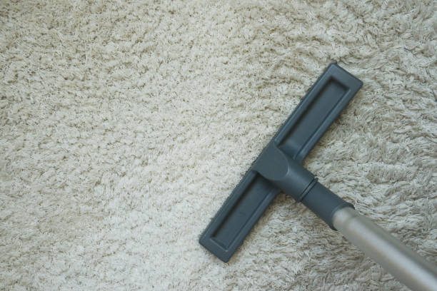 istock Vacuum cleaner on woolen carpet. House cleaning concept. 1337619270