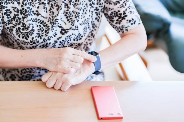 istock Japanese senior woman using smart watch 1337622698