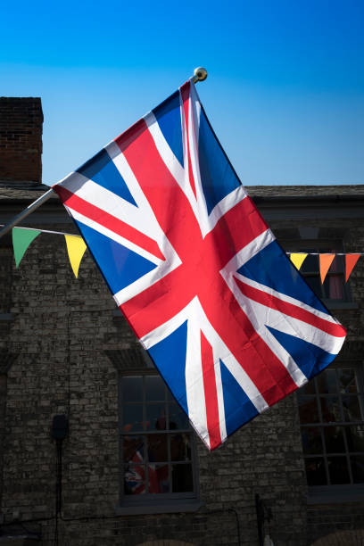 istock Union Jack and bunting backlit in market town 1337622762