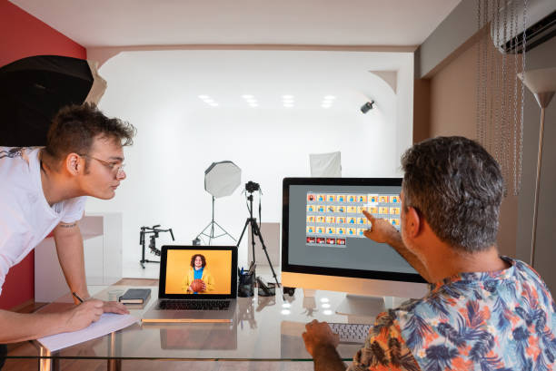 istock Two photographers working on the computers in the studio 1337623475