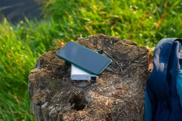 istock Smartphone is charged using a portable charger. Power Bank charges the phone outdoors with a backpack for tourism in nature. 1337626575