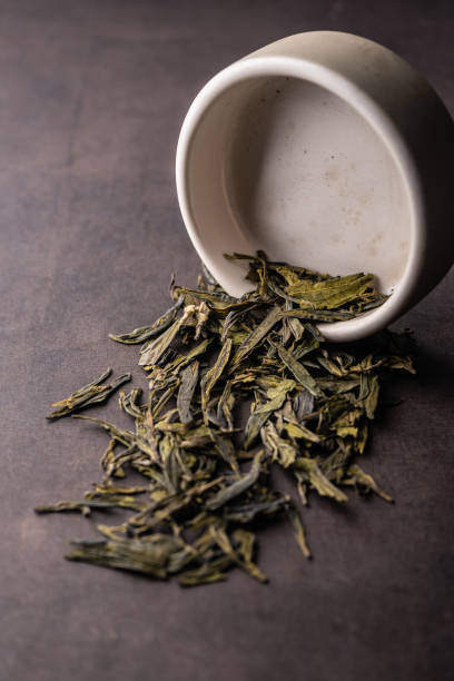 istock selective focus, natural green leaf tea in a clay bowl 1337626706