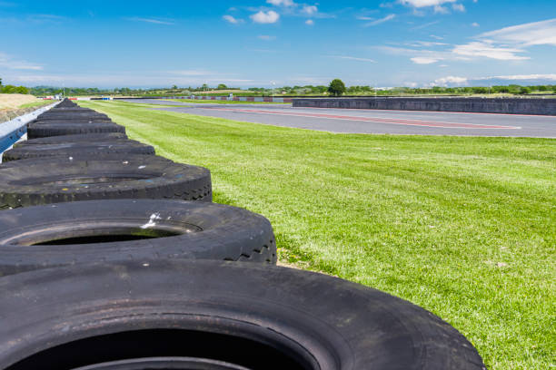 istock Tyres line the crash barrier at a racetrack 1337627321
