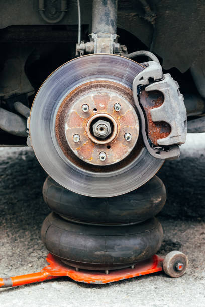 istock Car wheel hub with brake disc at tire shop 1337627549