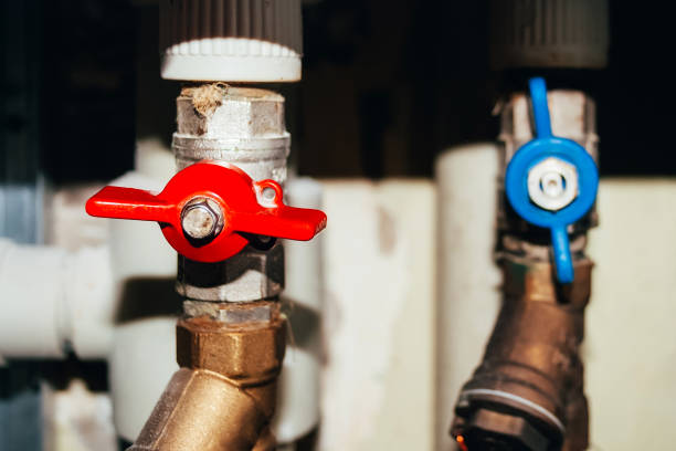 Two valves on pipes with hot and cold water