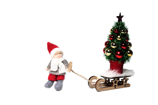 Christmas elf with decorated christmas tree isolated on white background