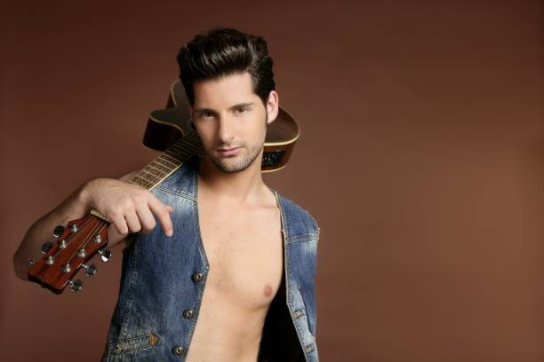 istock sexy young man musician guitar player on brown 1337628490