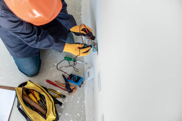 Man testing electricity with multimeter Man testing electricity with multimeter using safety equipment electrician stock pictures, royalty-free photos & images