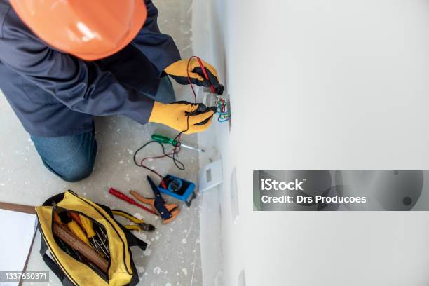 Man Testing Electricity With Multimeter Stock Photo - Download Image Now - Electrician, Work Tool, Residential Building