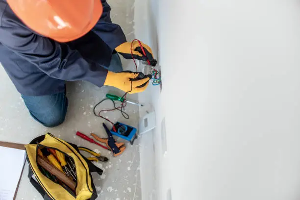 Photo of Man testing electricity with multimeter