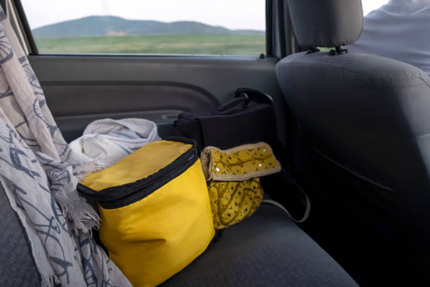 Yellow cooler bag in the back seat. Travel/ road trip concept.