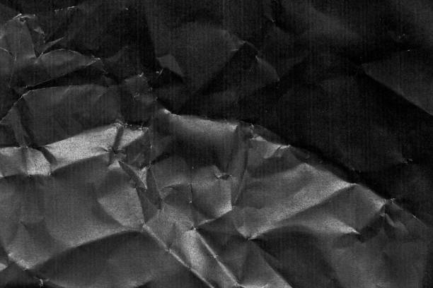 istock Grunge wrinkled black color paper textured background 1337631978