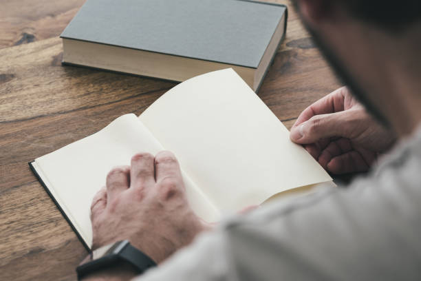 istock person sitting an wooden table reading a book 1337632586