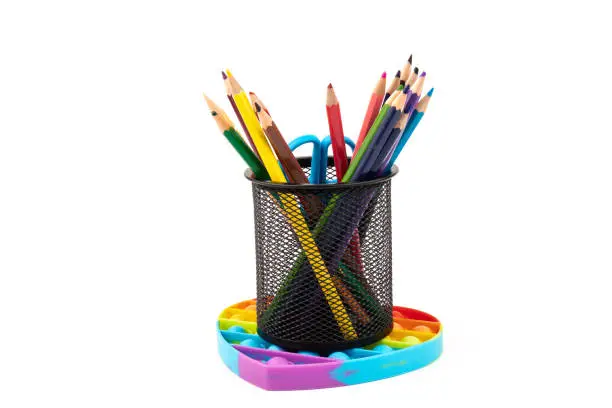 Photo of School supplies, children toy popit anti-stress on white background. Concept of the back to school.