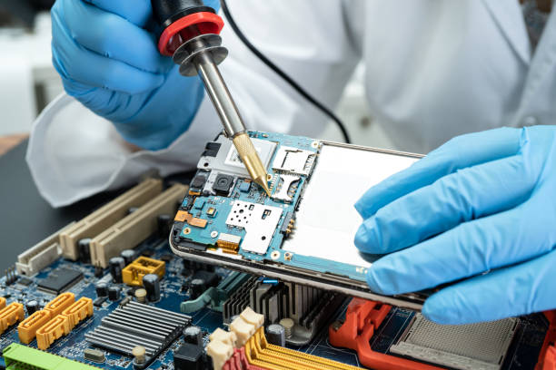 istock E-waste, technician repairing inside of hard disk by soldering iron. Integrated Circuit. the concept of data, hardware, technician and technology. 1337634005