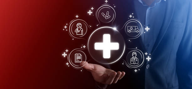 istock Businessman hold virtual plus medical network connection icons. Covid-19 pandemic develop people awareness and spread attention on their healthcare.Doctor,document,medicine,ambulance,patient icon. 1337639434