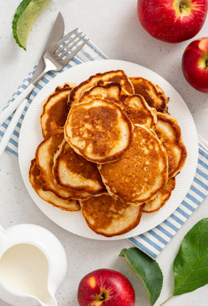 Homemade apple pancakes Homemade apple pancakes in a white plate on a gray concrete background top view. Tasty breakfast dissert stock pictures, royalty-free photos & images