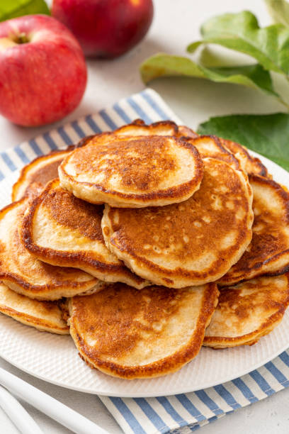 Homemade apple pancakes Homemade apple pancakes in a white plate on a gray concrete background. Tasty breakfast dissert stock pictures, royalty-free photos & images