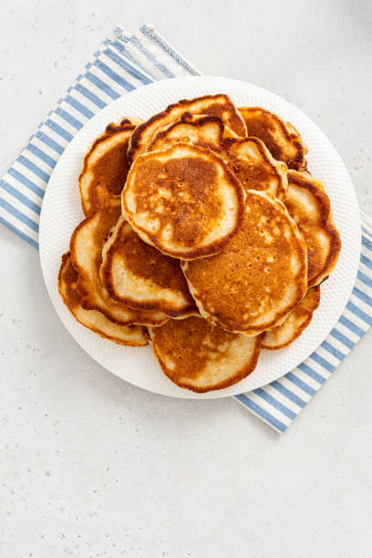 Homemade pancakes Homemade pancakes in a white plate on a gray concrete background top view. Copy space for text. Tasty breakfast dissert stock pictures, royalty-free photos & images