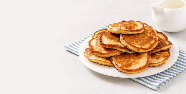 Homemade pancakes Homemade pancakes in a white plate on a gray concrete background. Copy space for text. Tasty breakfast dissert stock pictures, royalty-free photos & images