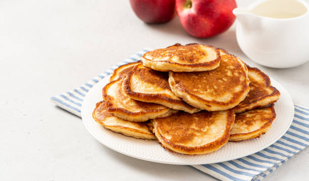 Homemade apple pancakes Homemade apple pancakes in a white plate on a gray concrete background. Copy space for text. Tasty breakfast dissert stock pictures, royalty-free photos & images