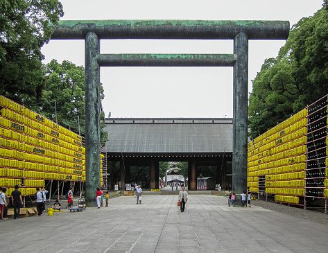 Tokyo, Japan - July 17, 2009: Paper lanterns and second Gate (Daini Torii) at Yasukuni Shrine. Lanterns are displayed along the entrance and inside the shrine to help spirits find their way during the annual celebration for the spirits of ancestors